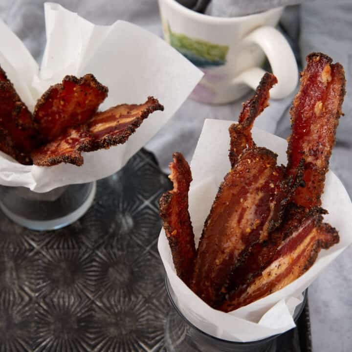 Parchment lined cups of candied bacon.
