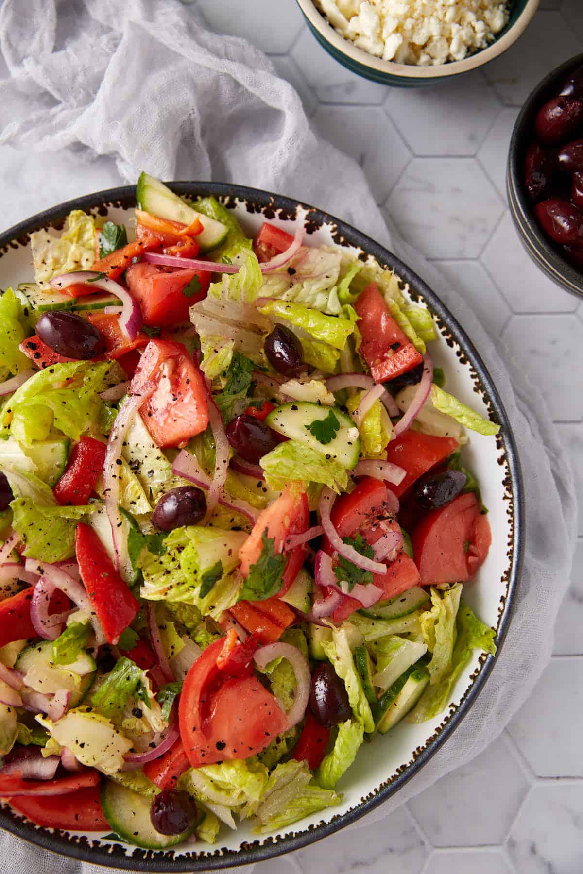 Fresh and tangy Greek salad with cucumbers and zesty lemon dressing in a serving bowl.