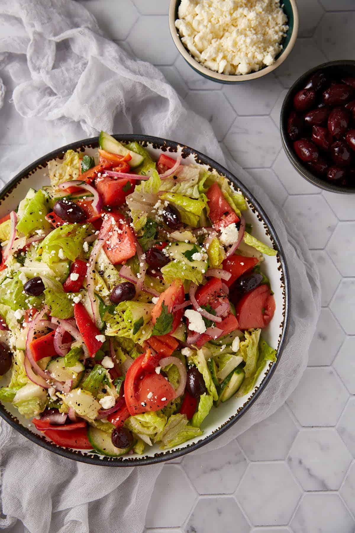 Colorful and flavorful Greek salad made with cucumbers and a zesty lemon dressing in a serving bowl.