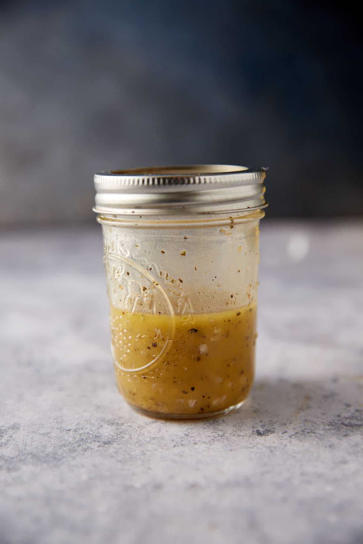 Salad dressing in a jar after it has been shaken.