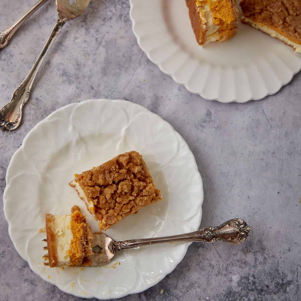 A bite of pumpkin cheesecake bars on a fork.