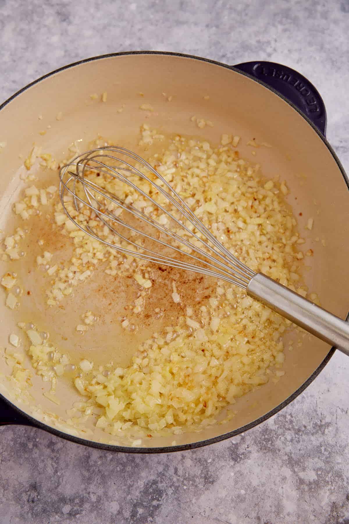 Sauted onions in a skillet.