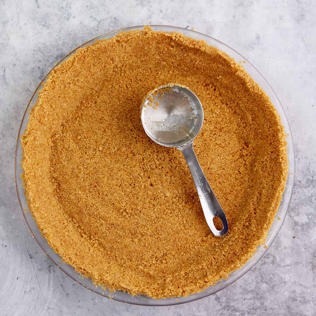 Graham crackers being formed into a crust.