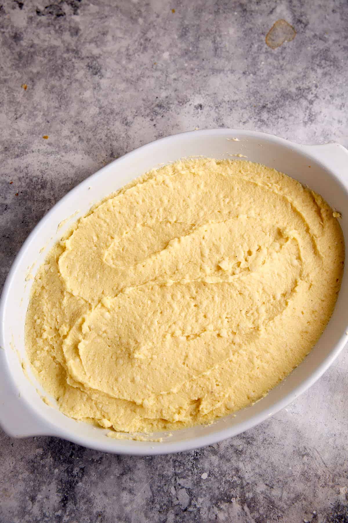 Spoon bread batter in a baking dish.