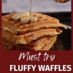 Syrup being poured over fluffy waffles.