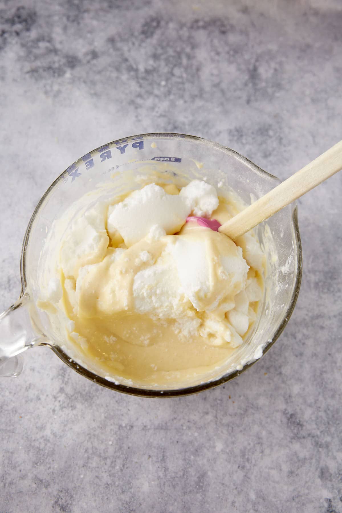 Egg whites folded into a bowl of waffles batter.