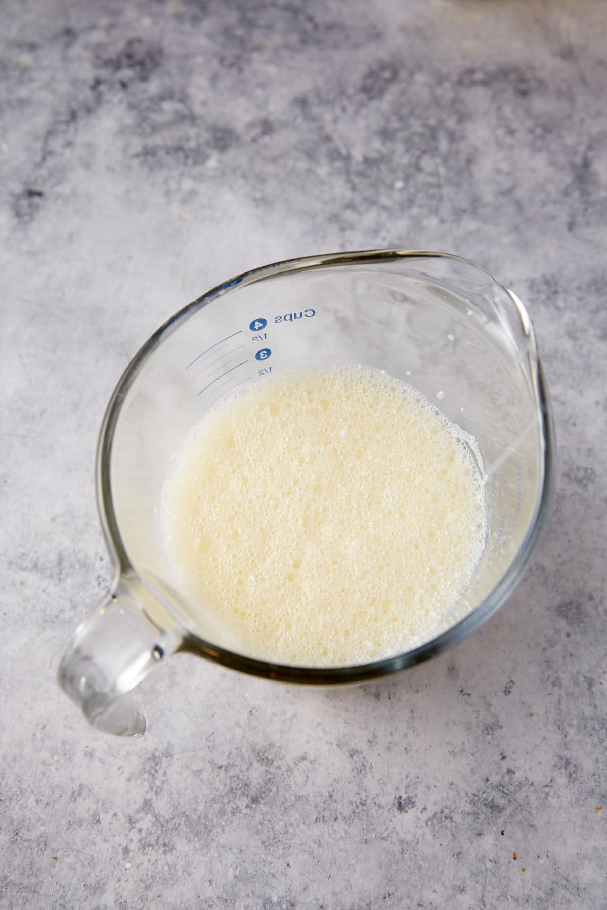 Egg yolks and milk in a bowl.