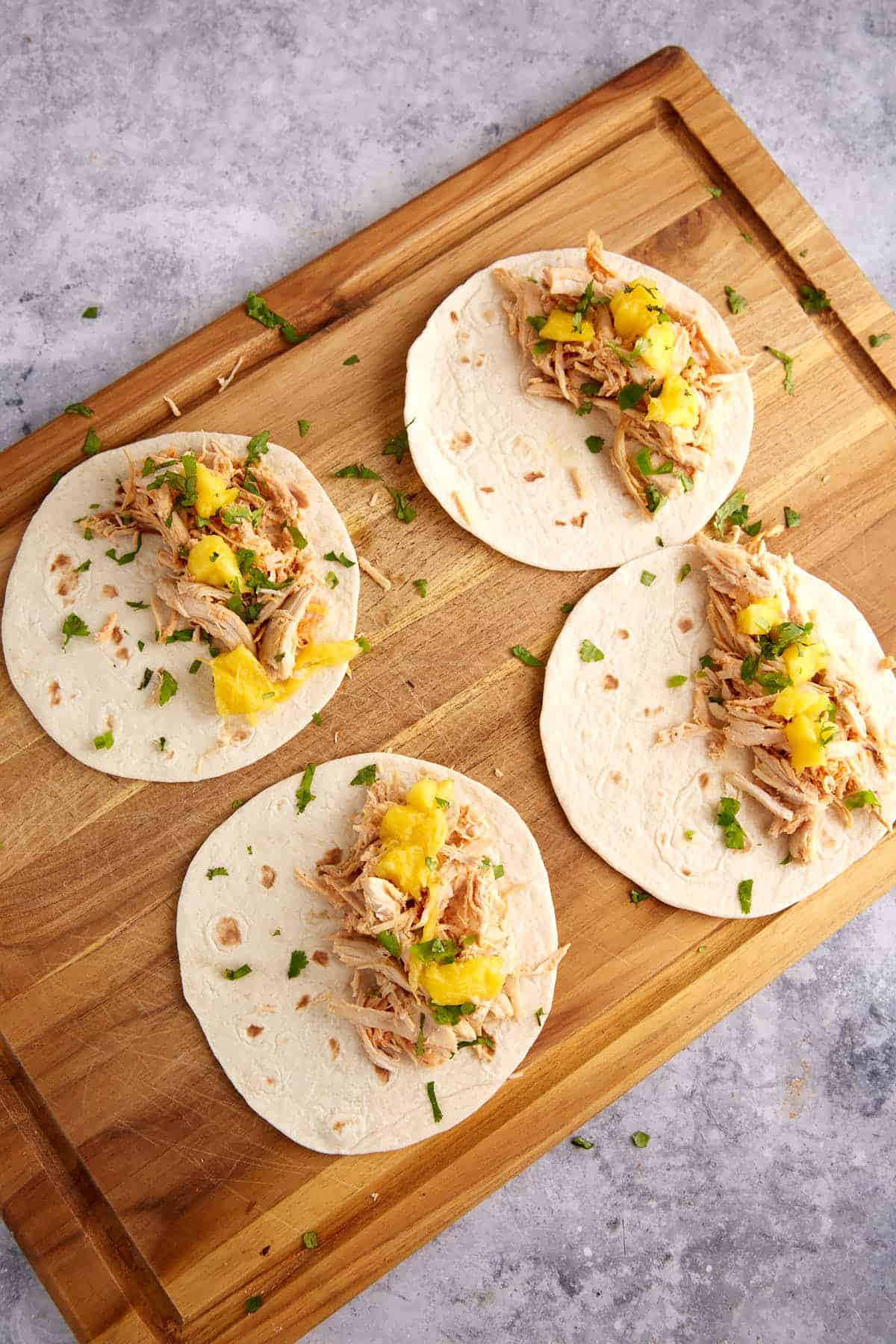 Chicken with mango on tortillas.