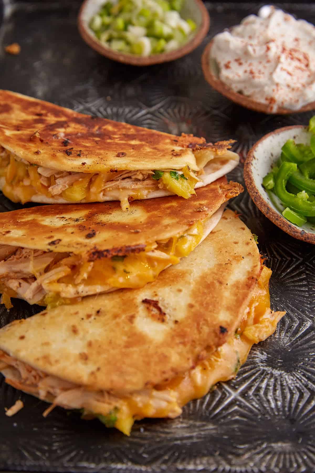 Cheese coming out of a chicken quesadilla.