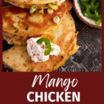 Three quesadillas with a scoop of sour cream.