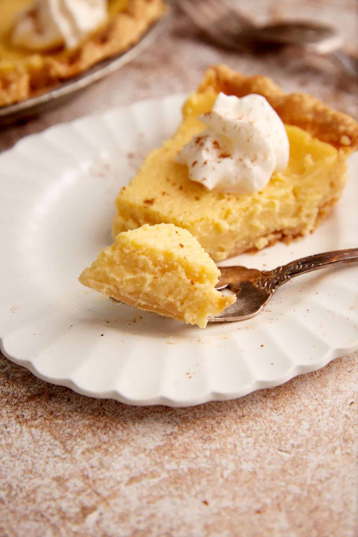 A bite of eggnog pie on a fork.