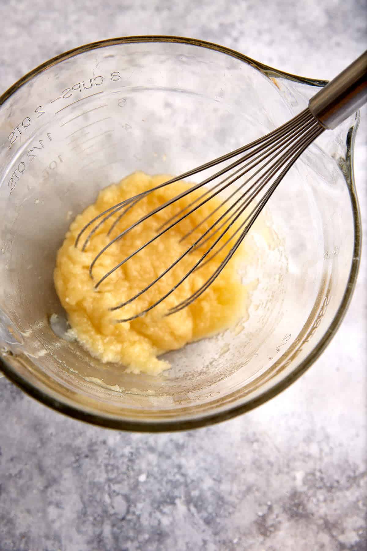 Sugar and butter whisked in a bowl.