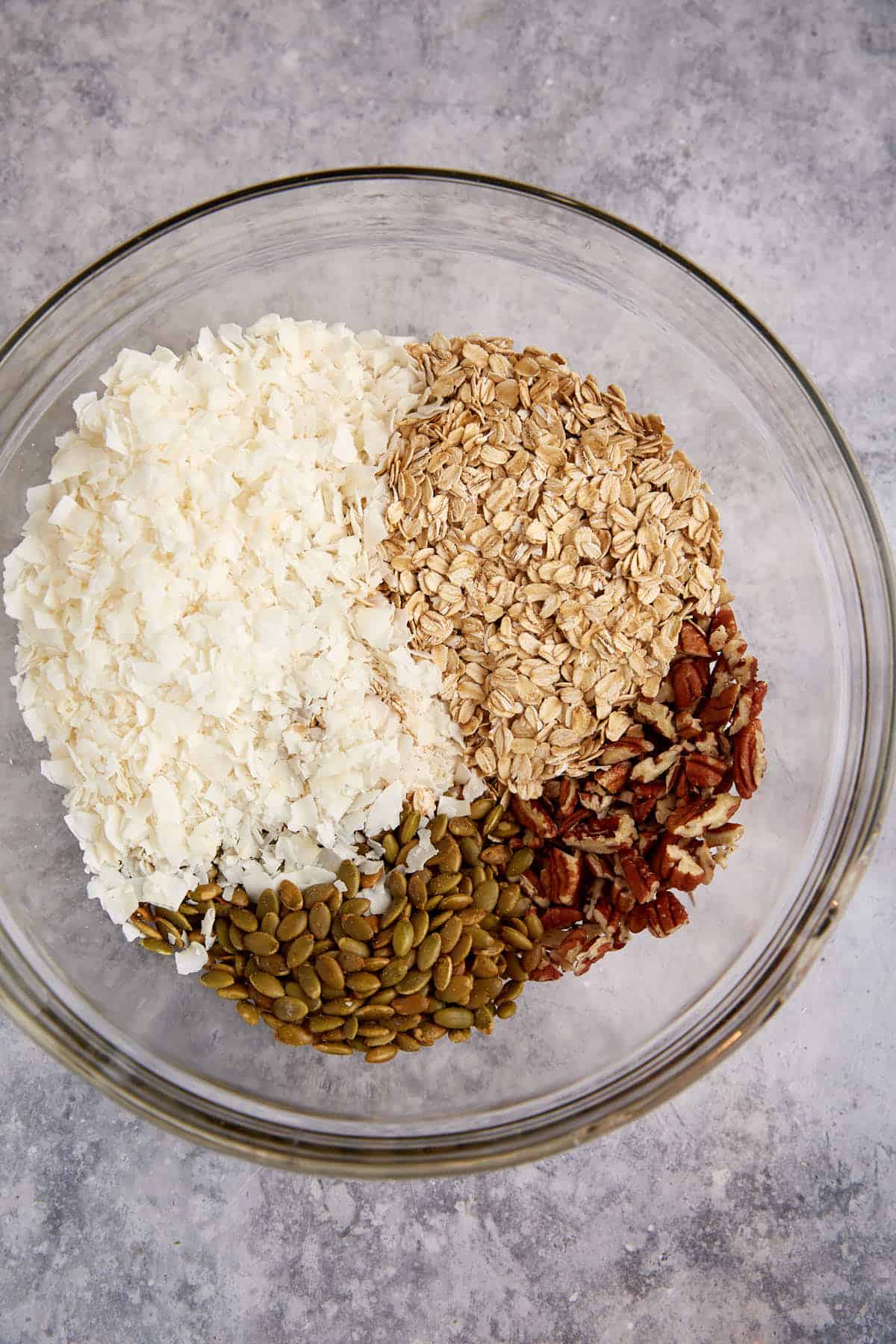 The dry ingredients for granola in a bowl.