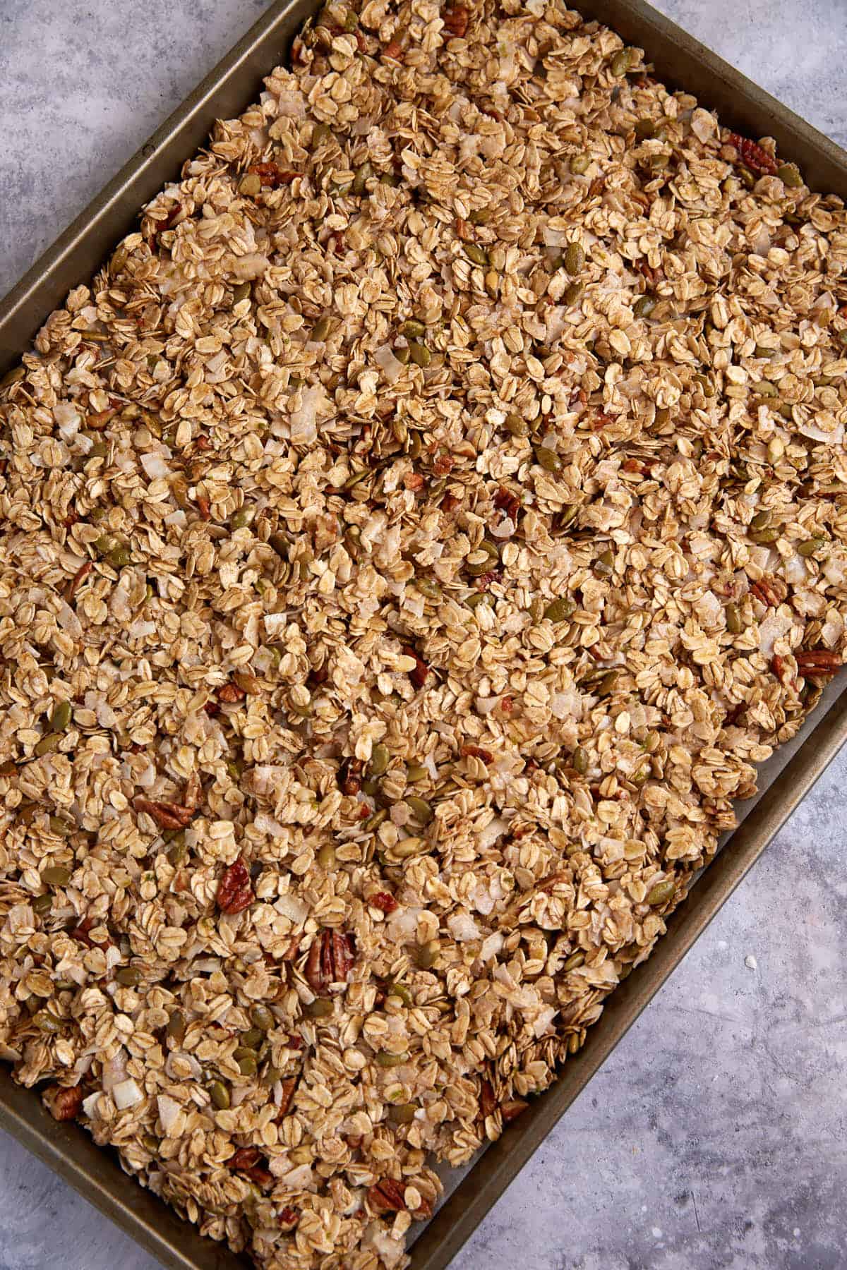 Uncooked granola on a baking sheet.