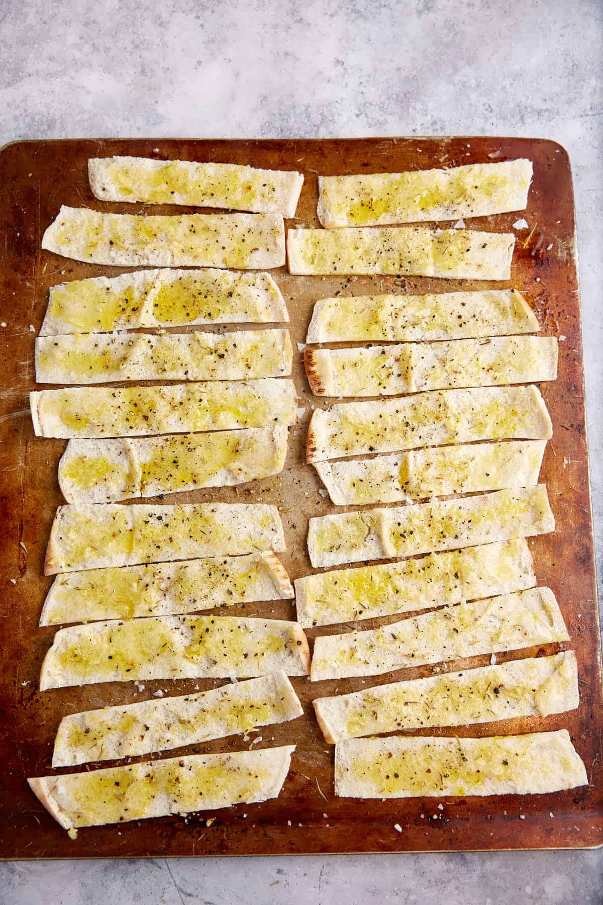 Pita chips on a baking sheet.