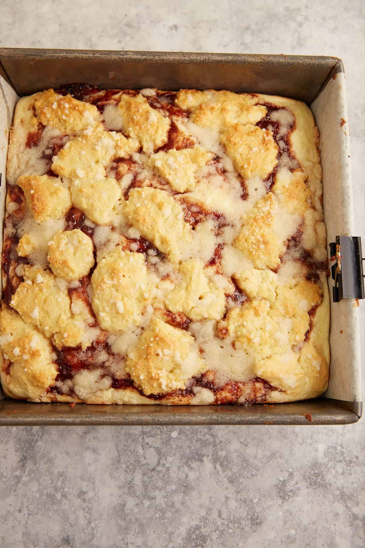 Baked cream cheese coffee cake in a baking pan.
