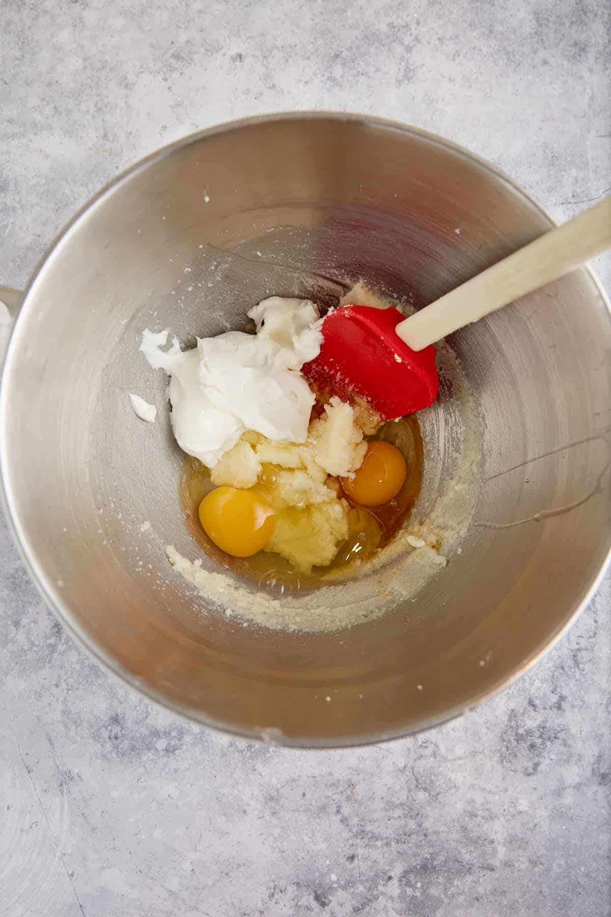 Yogurt and eggs being added to the cake batter.