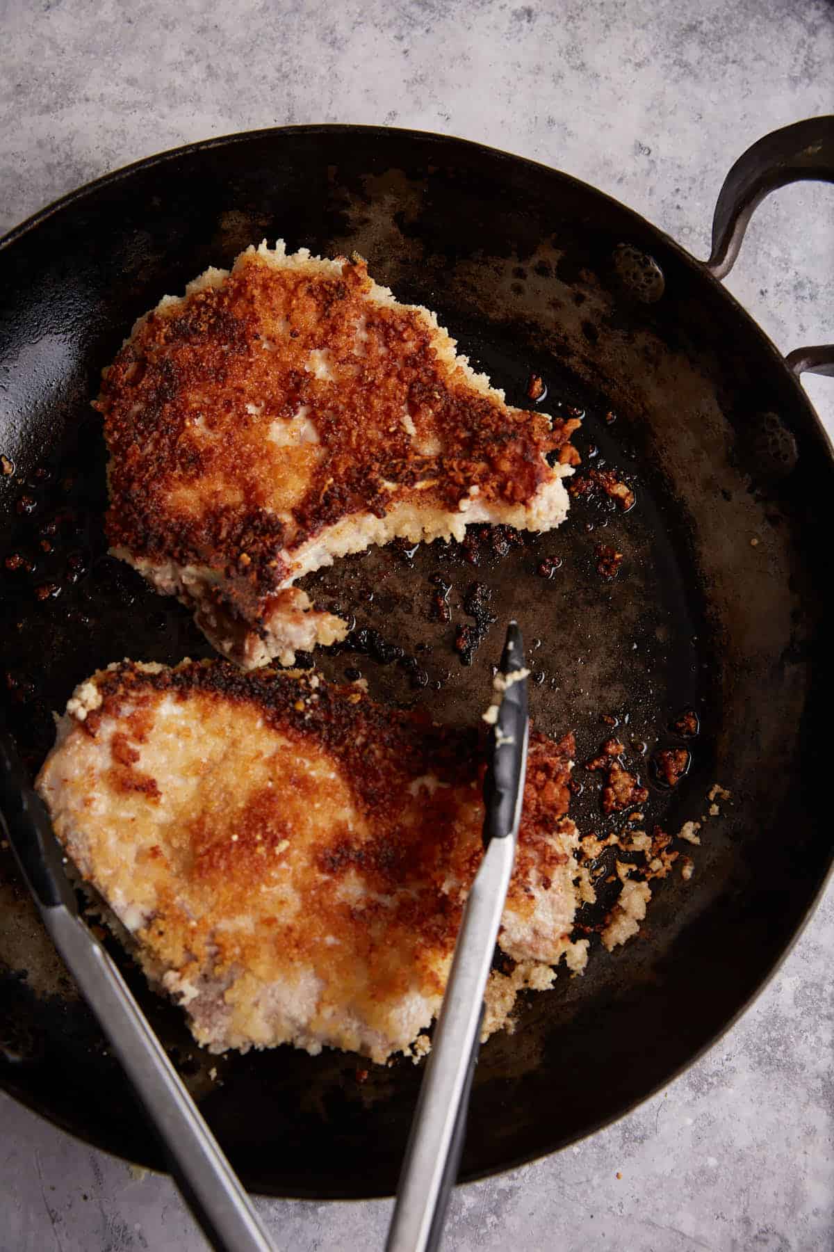 Pork chops cooked in a skillet.