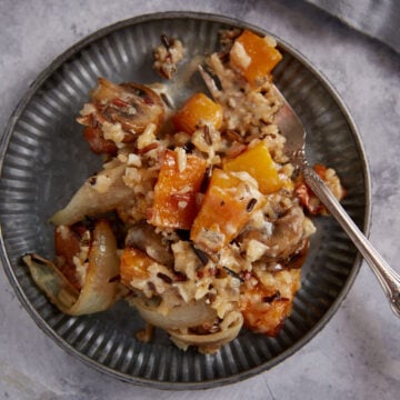 A plate of butternut squash casserole with a fork.