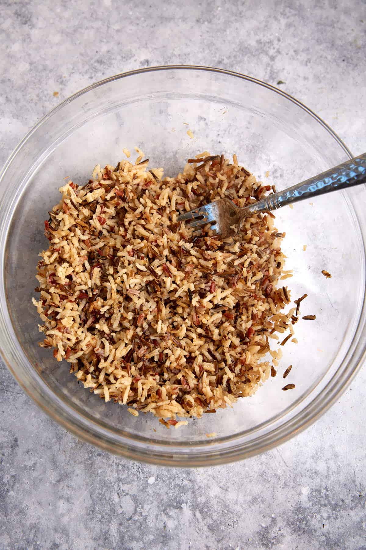 Cooked wild rice in a glass bowl.