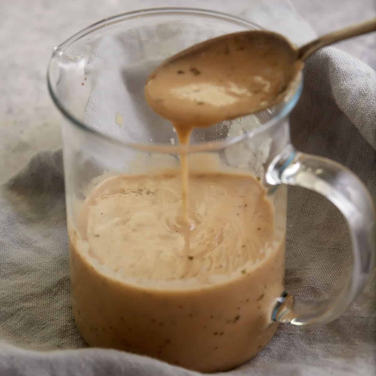 A glass container of cream of chicken soup.