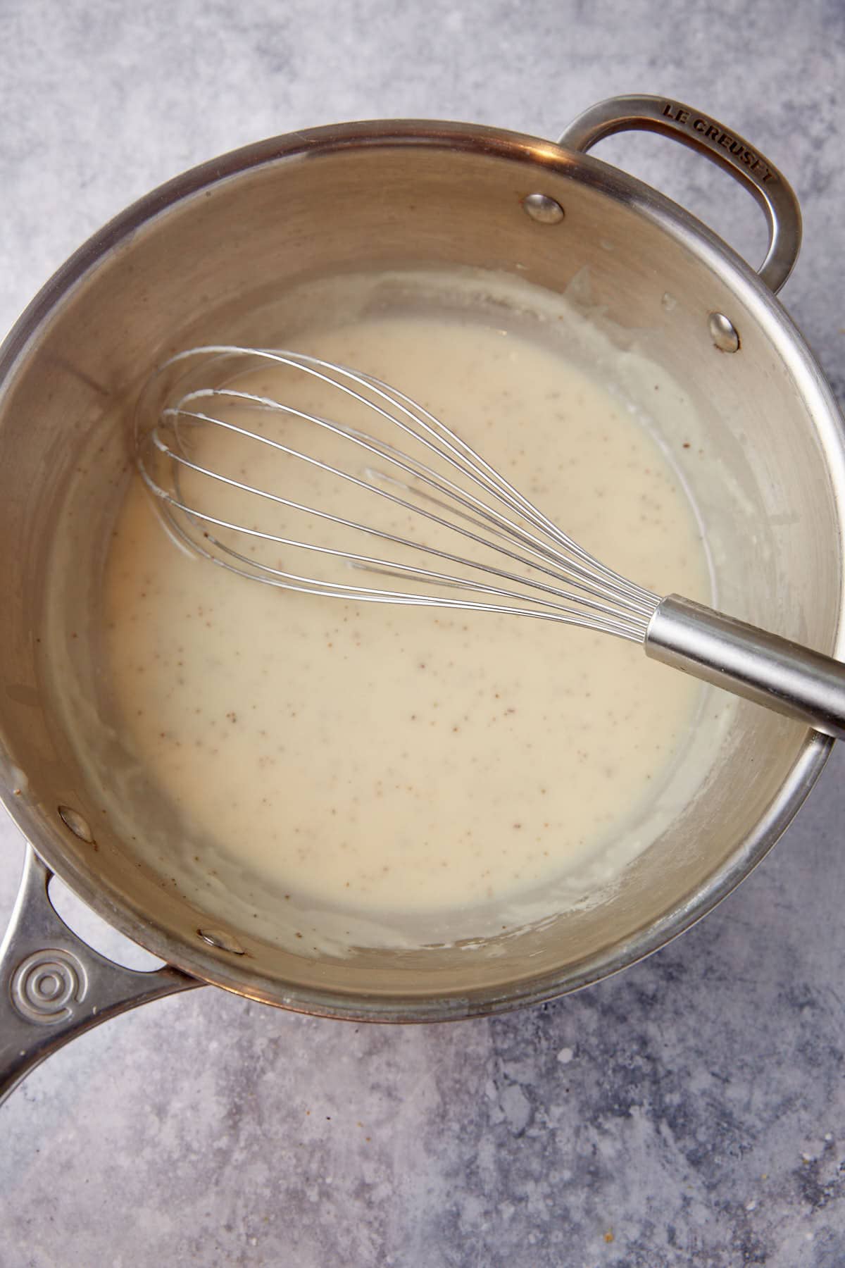 Milk and broth added to a saucepan.