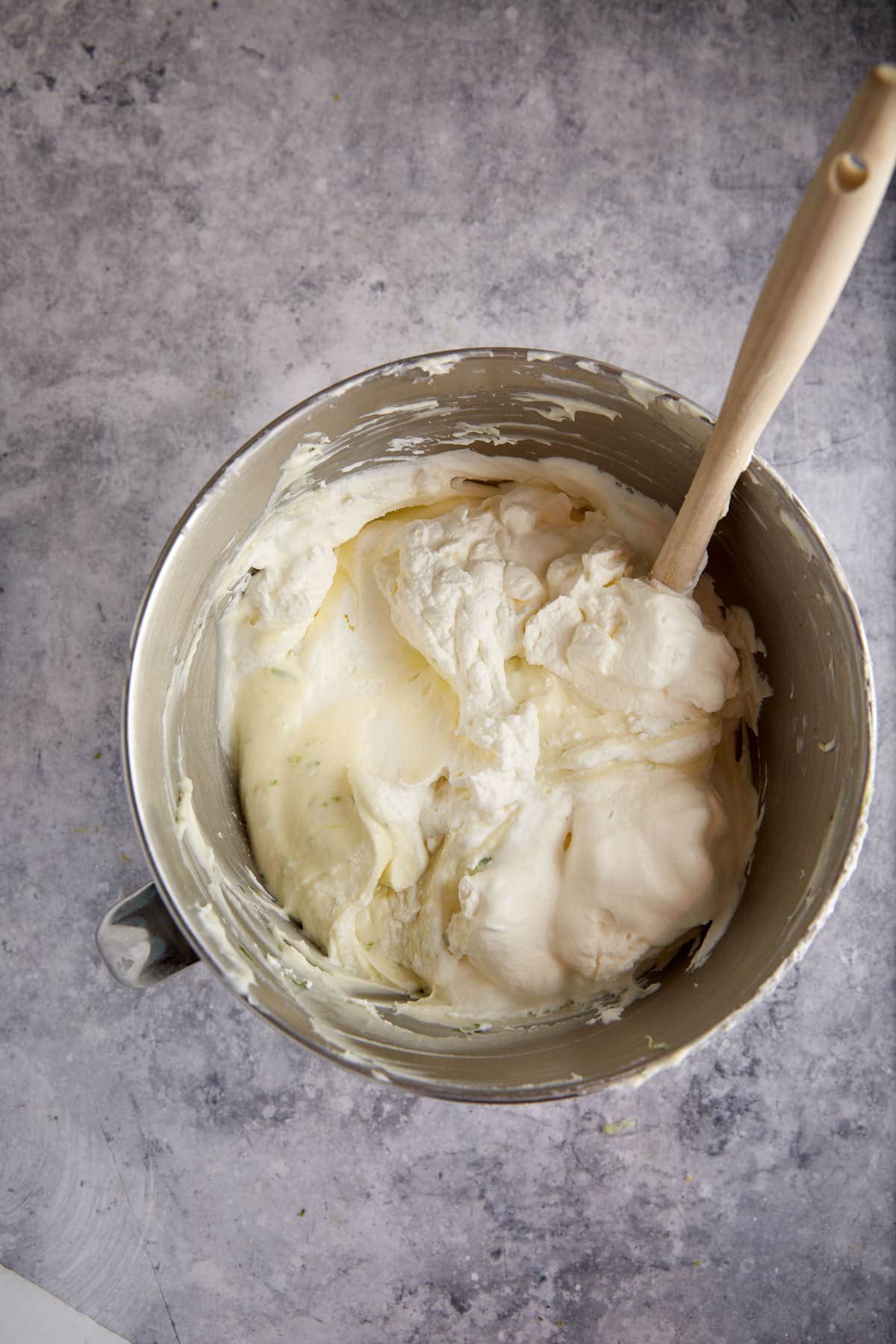 Whipped cream being folded into the cream cheese filling.