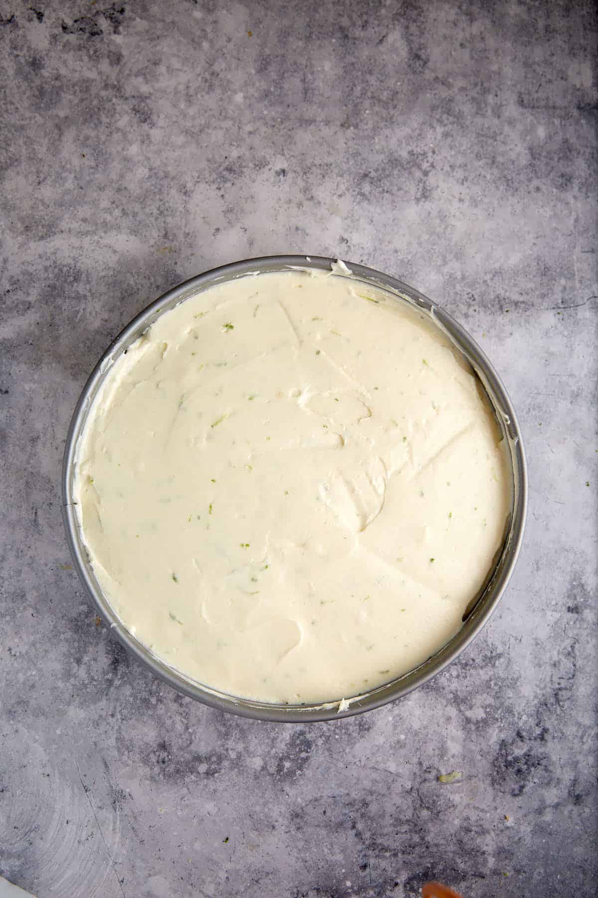 The key lime mousse poured into a springform pan.