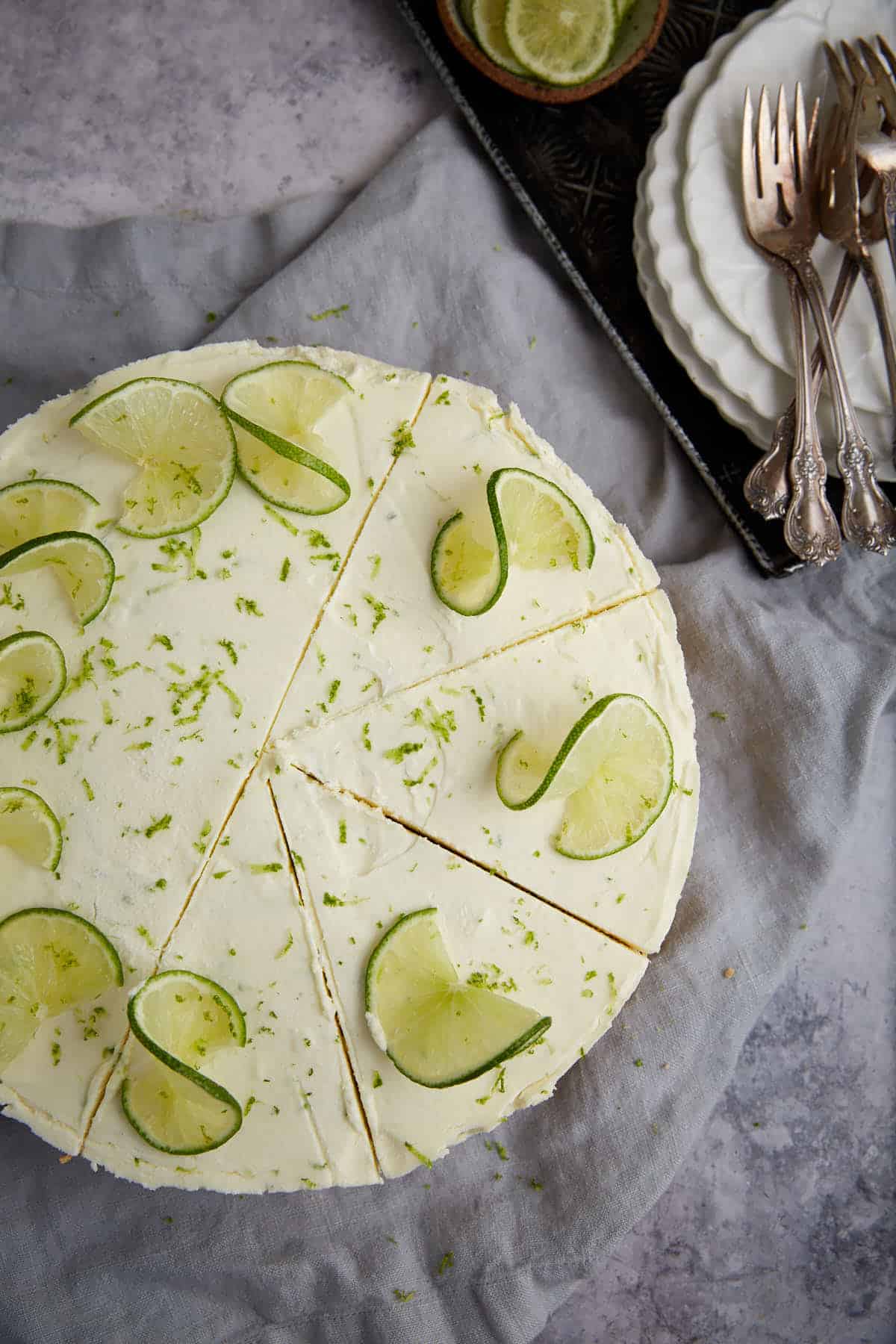 A key lime pie with sliced limes on top. 