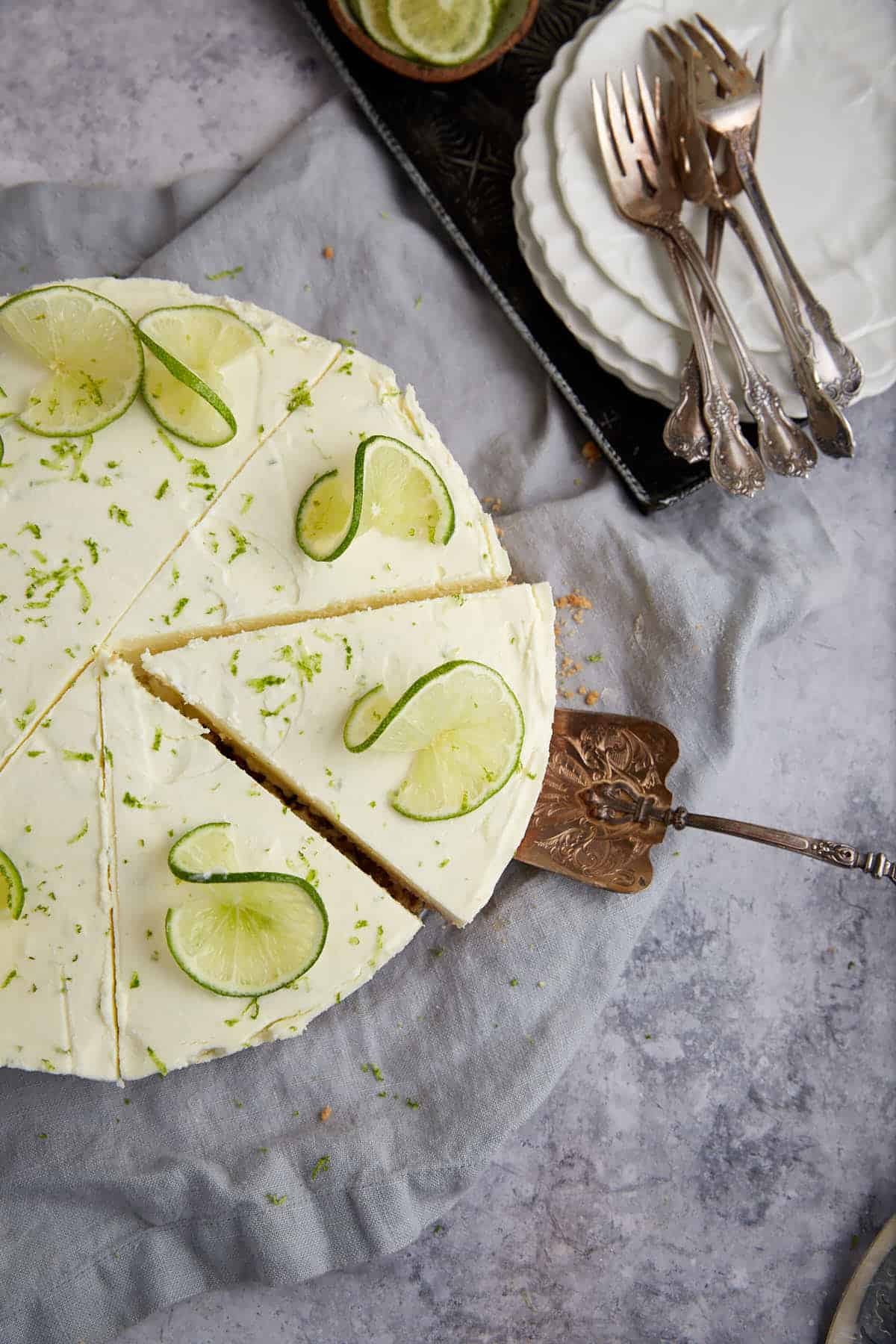 A slice being removed from a key lime pie.