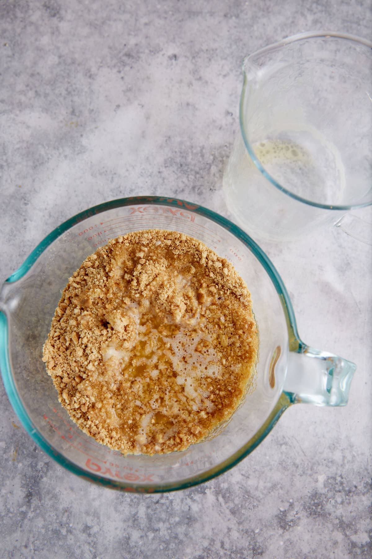 Butter poured over graham cracker crumbs.