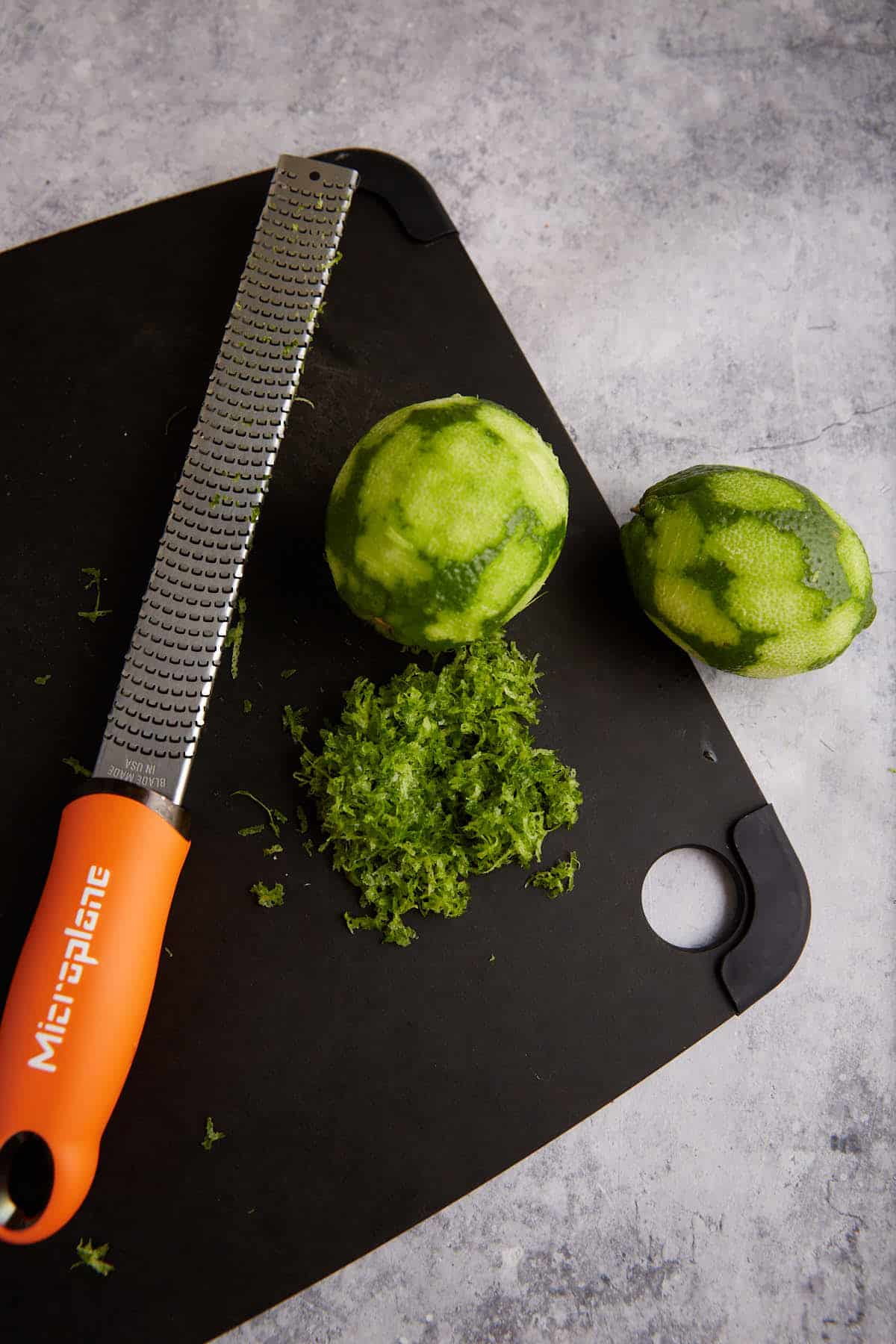 Lime zest on a cutting board.