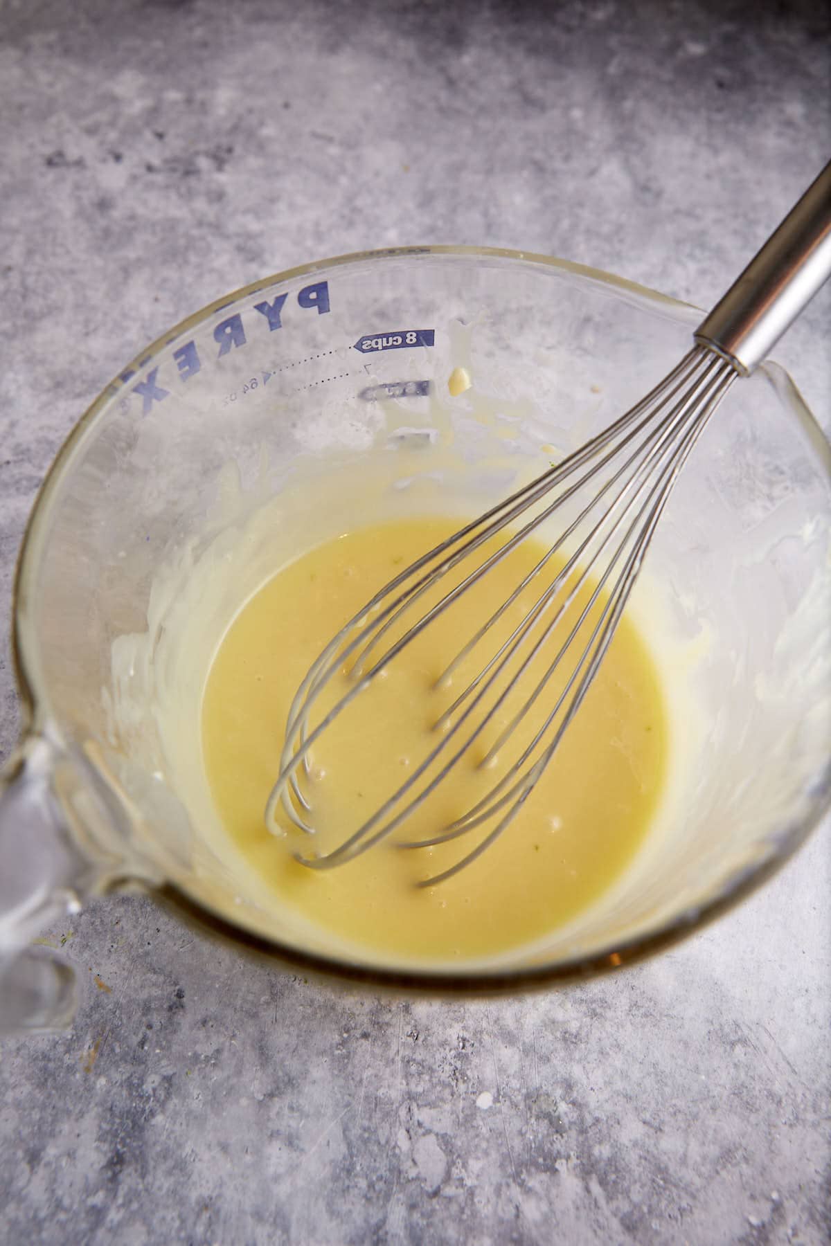 Cream and melted white chocolate in a bowl.