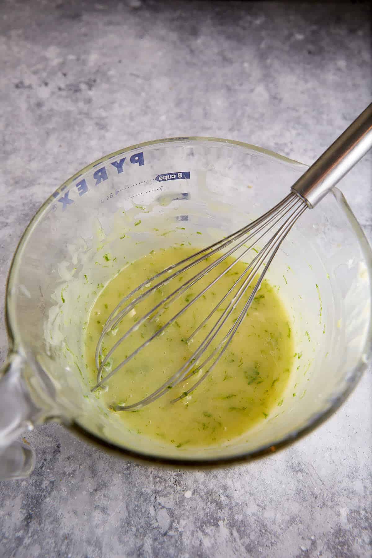 Lime mixture added to white chocolate ina bowl.