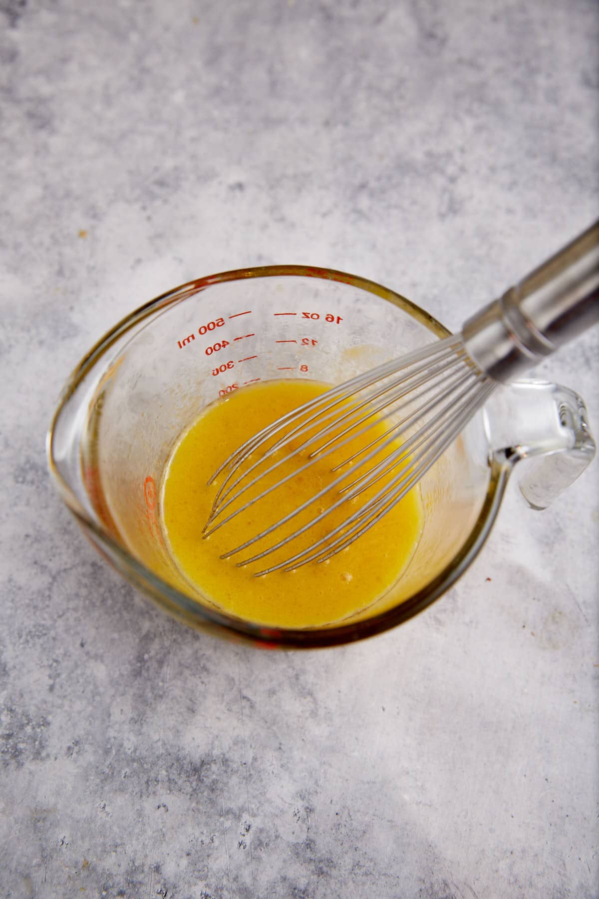 Eggs and oil in a measuring cup.