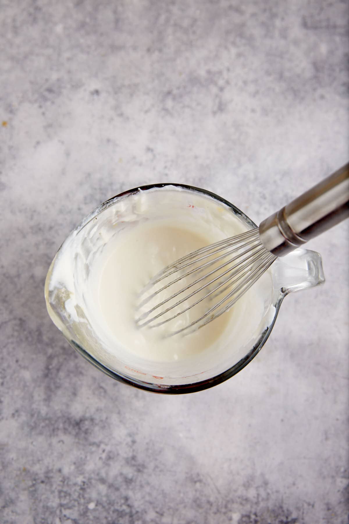 Buttermilk and sour cream in a measuring cup.