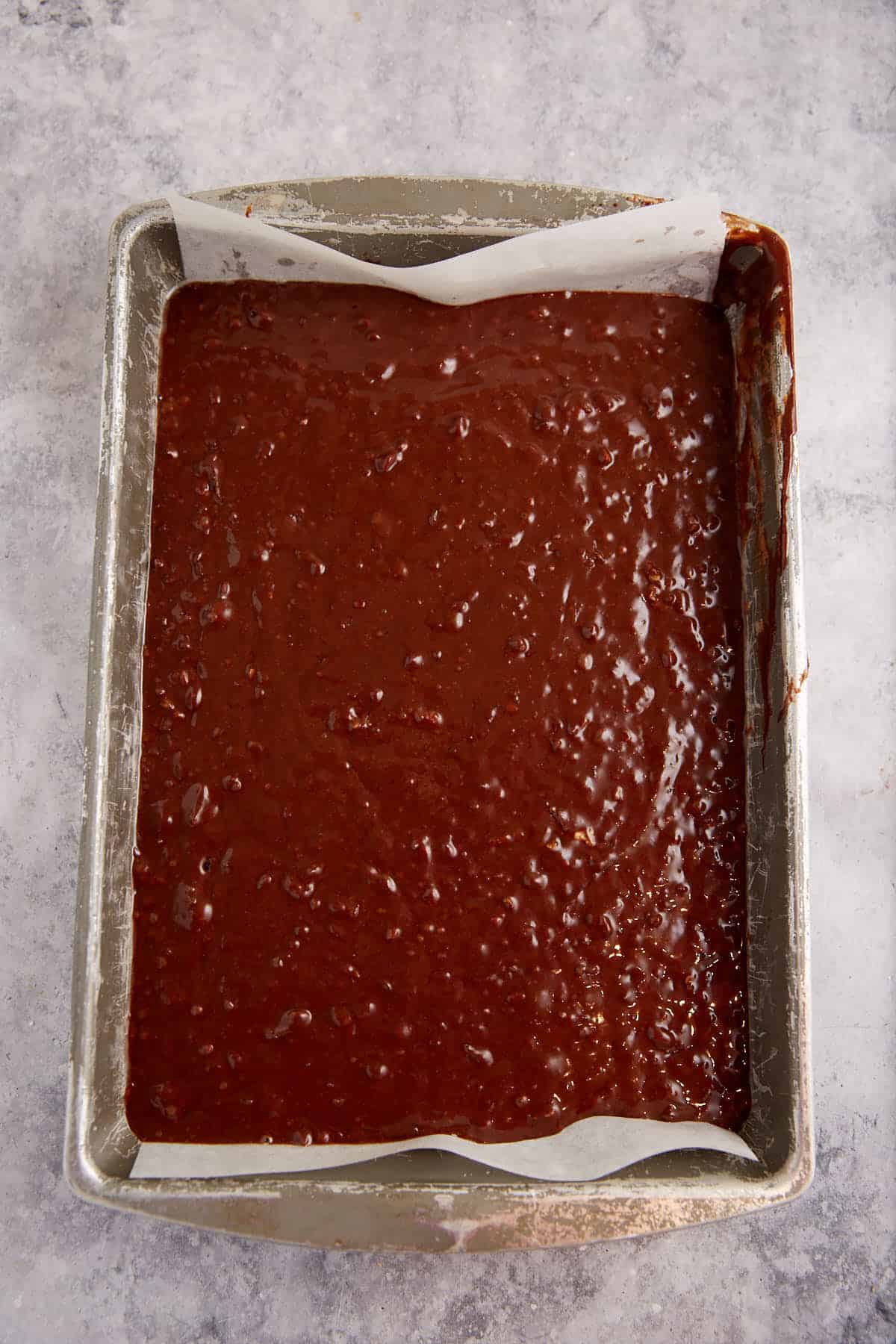 Chocolate cake batter in a baking pan.