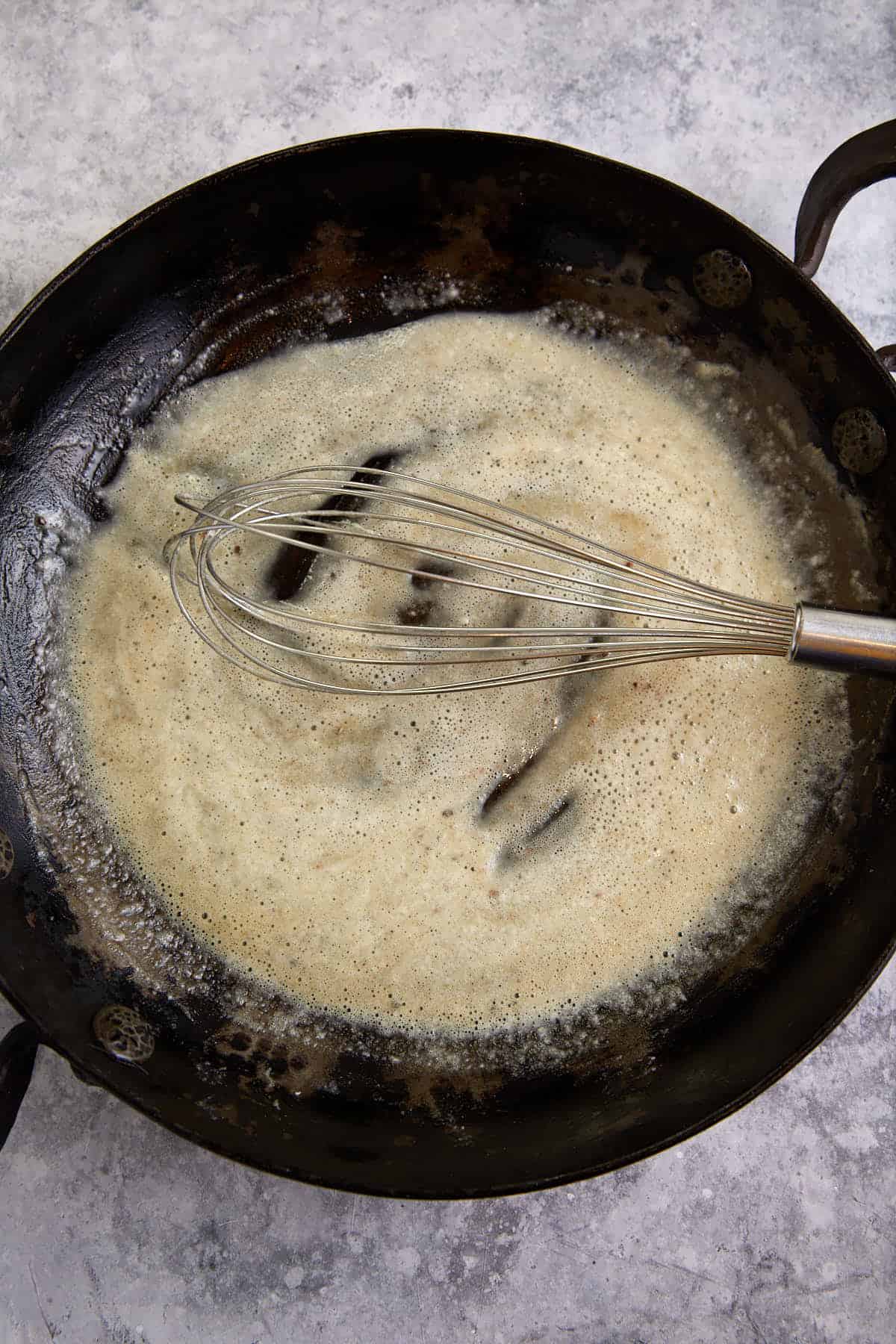 Butter and flour in a skillet with a whisk.