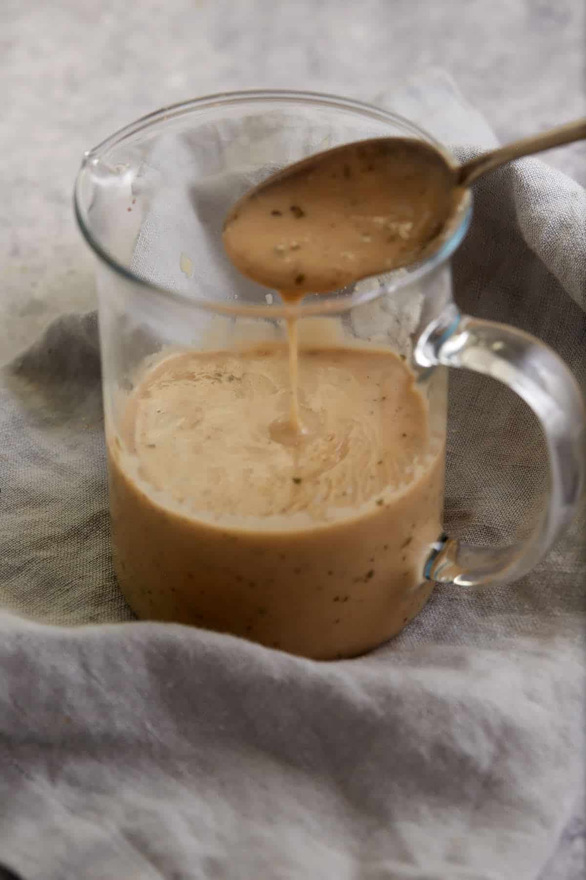 Gravy dripping off a spoon.