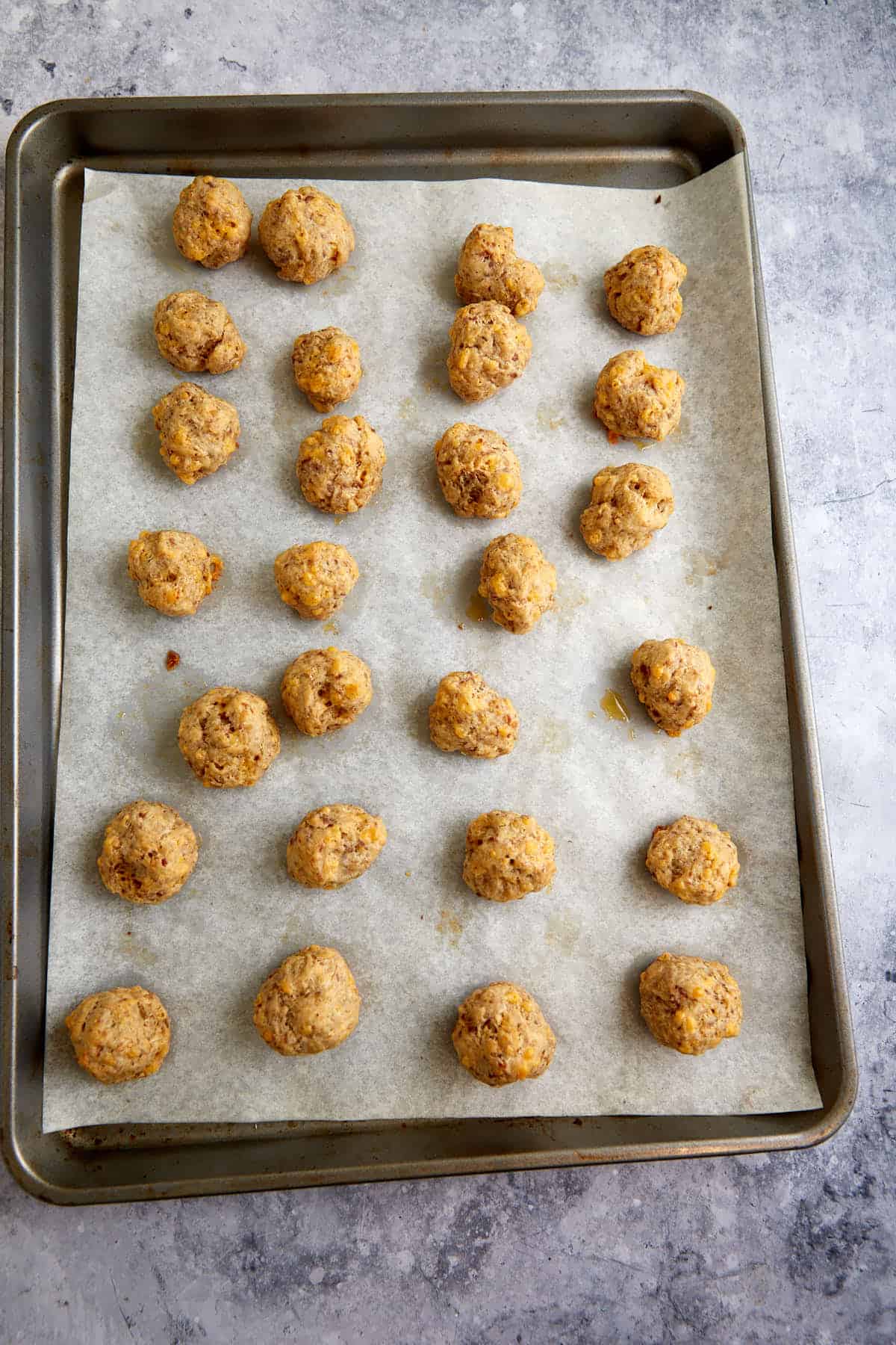 Baked sausage balls on a baking sheet.