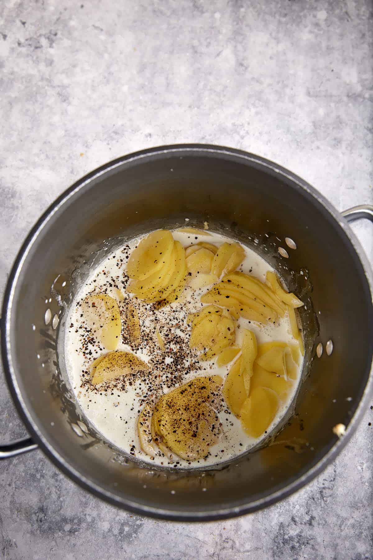 Potatoes and cream in a pot.