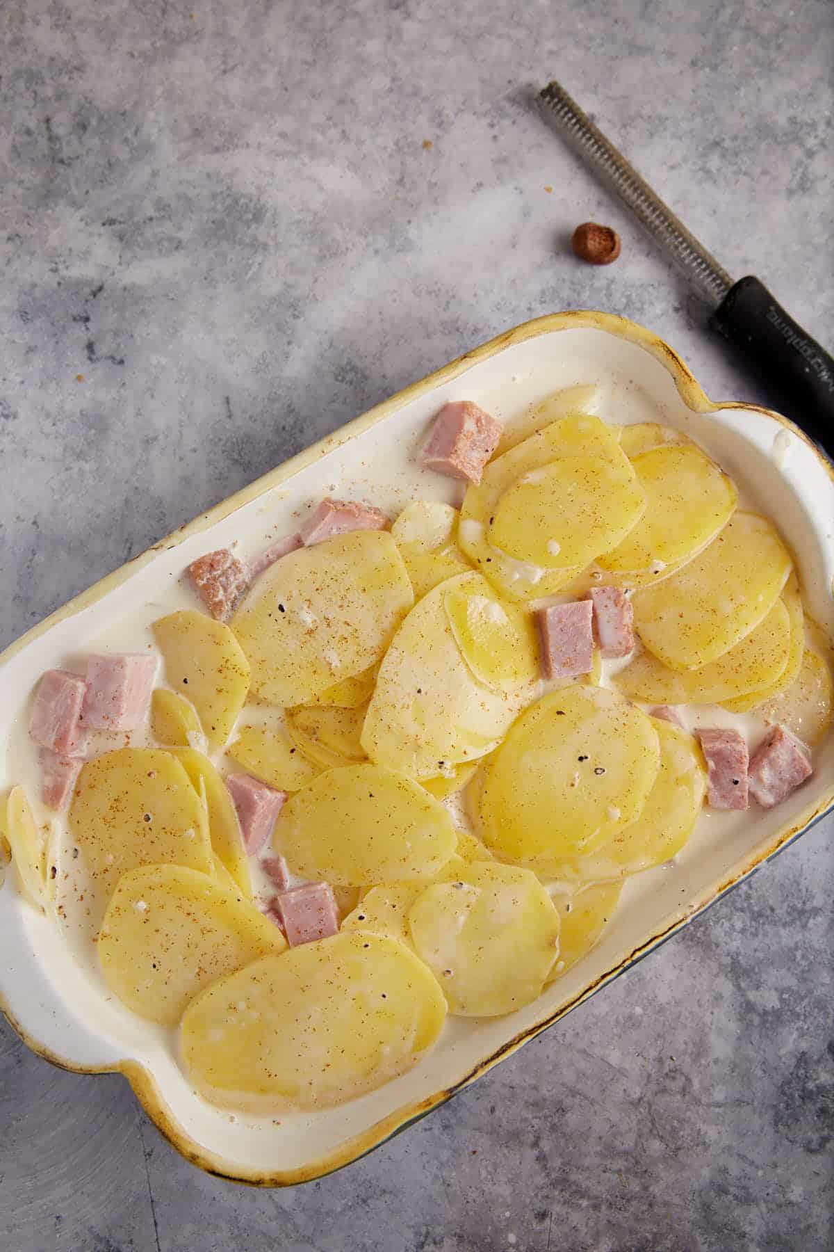 Potatoes and ham in a casserole dish.