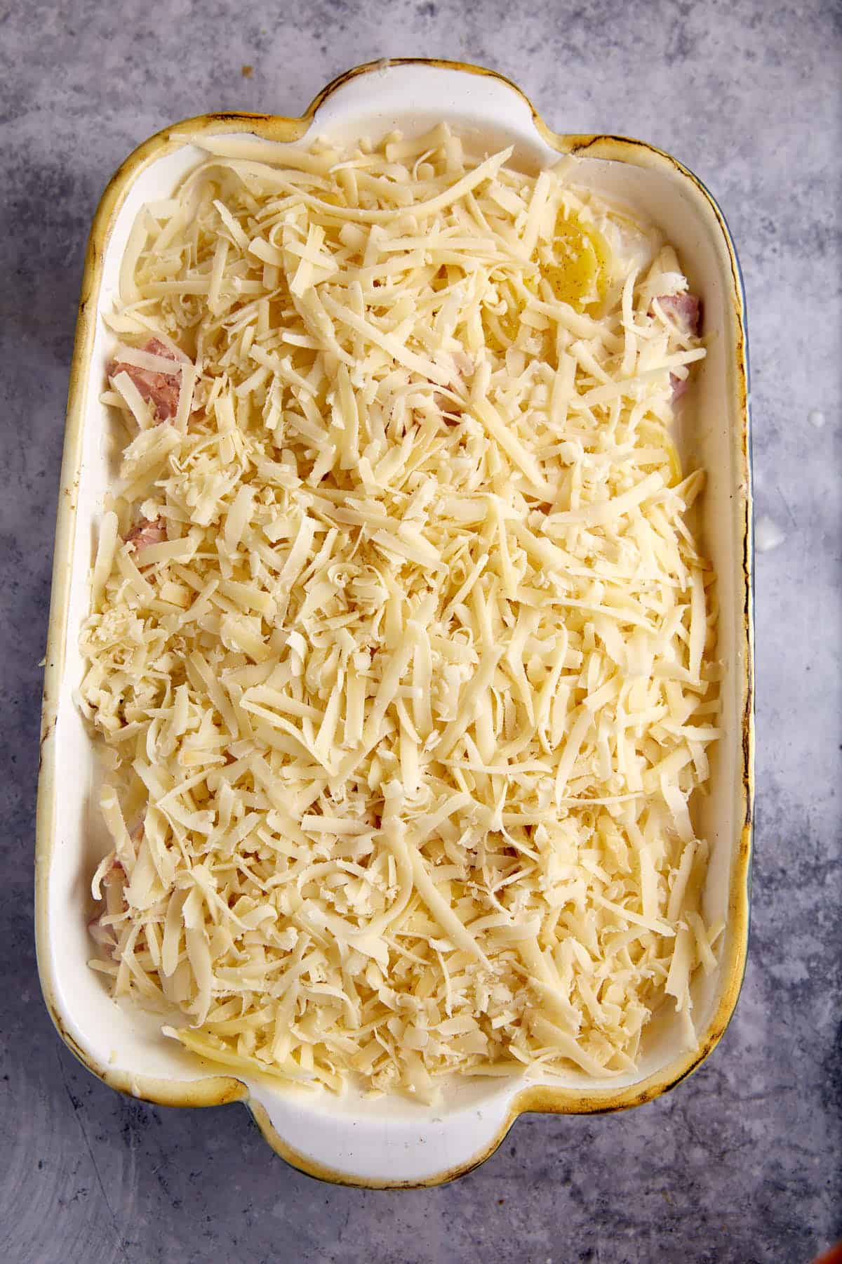 A potato and ham casserole covered in cheese.