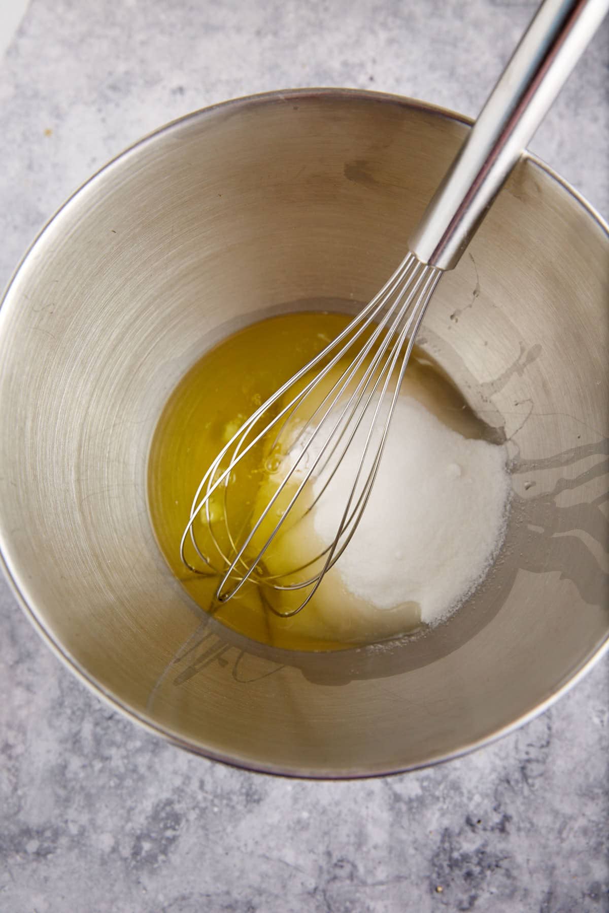 Egg whites and sugar in a mixing bowl.