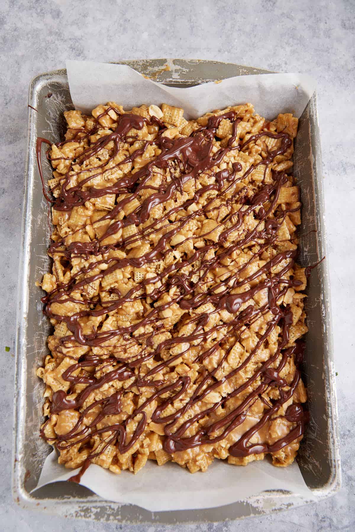 Chocolate drizzled over peanut butter squares.