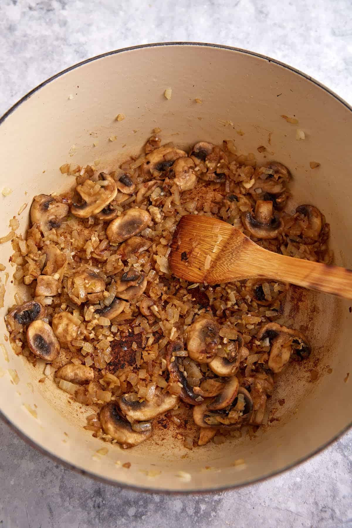 Mushrooms and onions cooked in a Dutch oven.