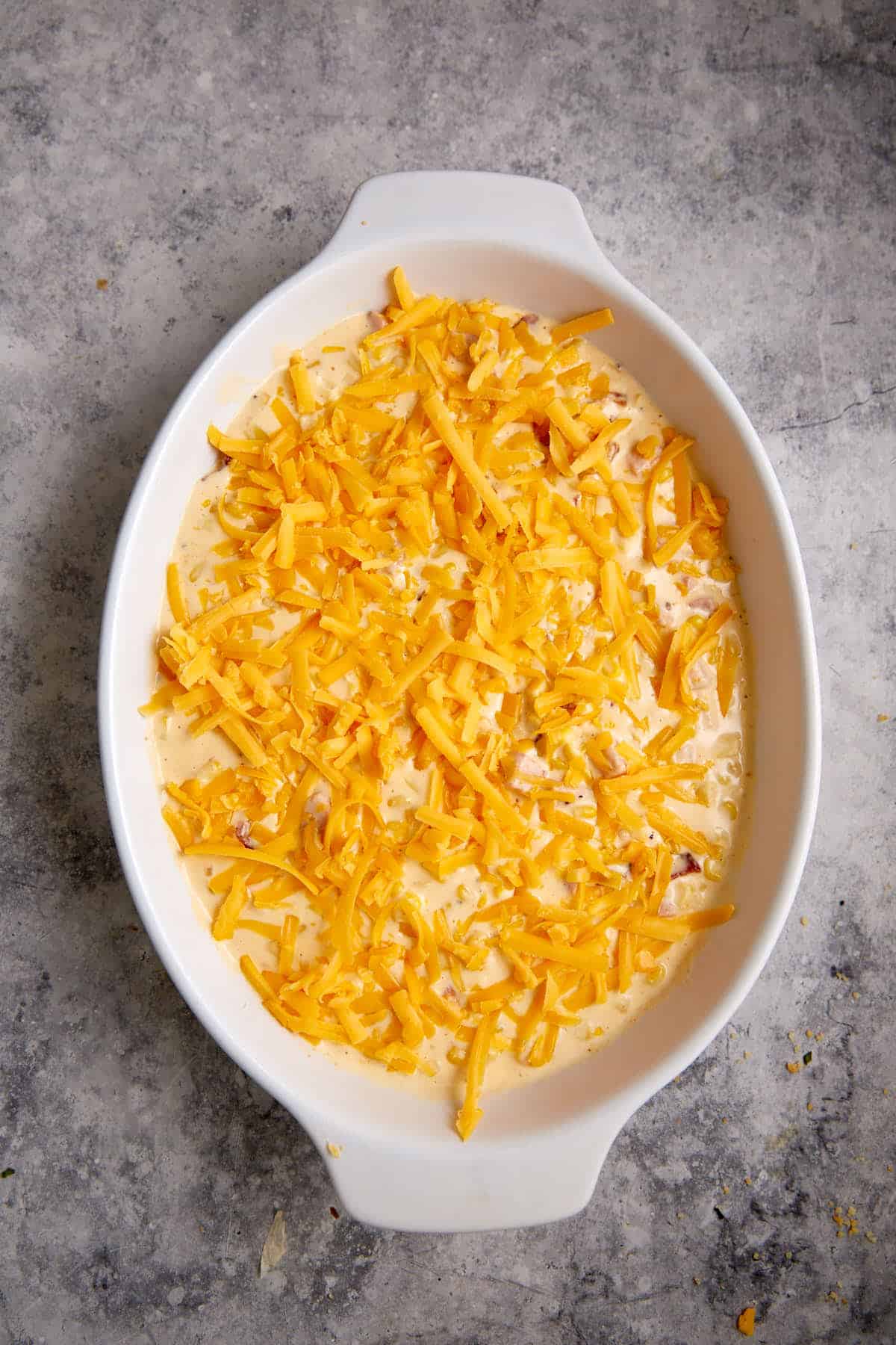 A casserole with cheese sprinkled on top.