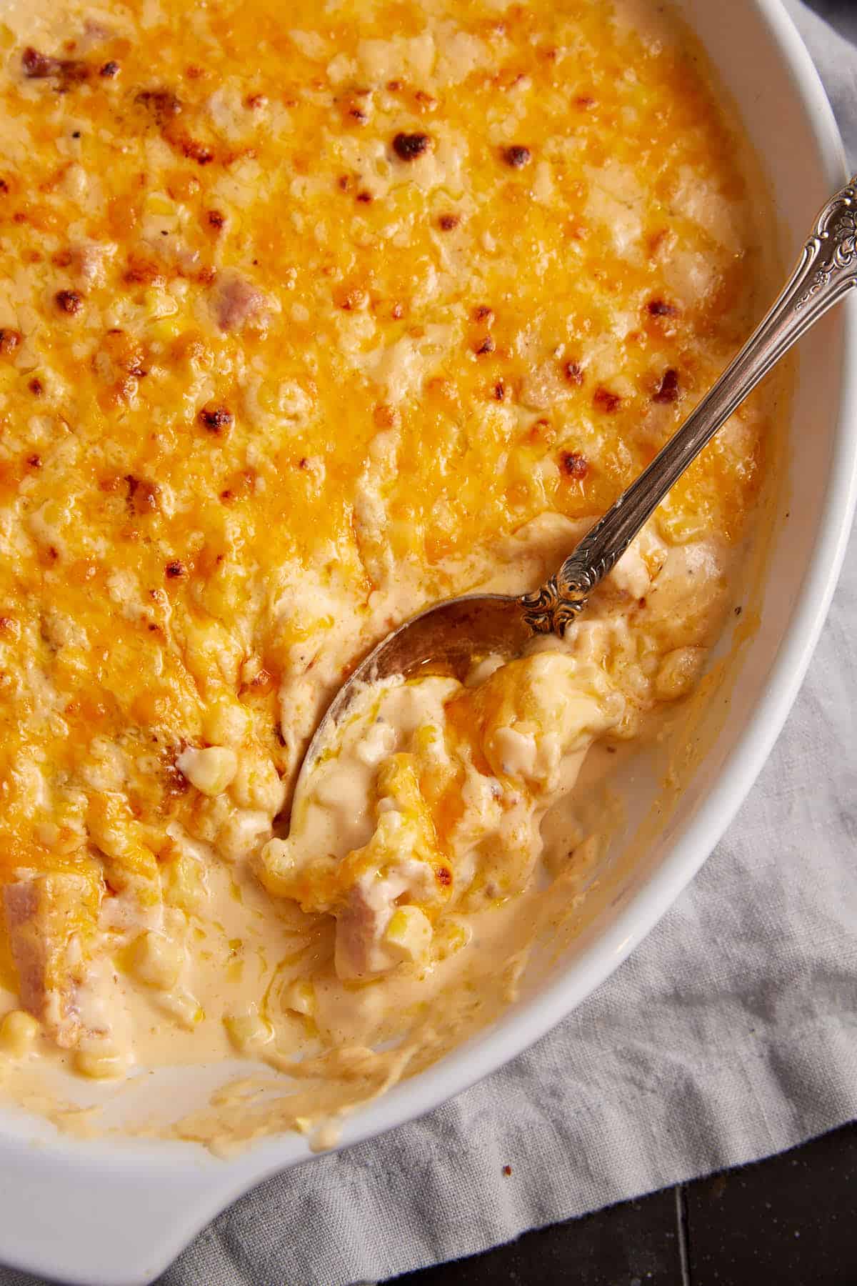 A serving spoon in a corn casserole.