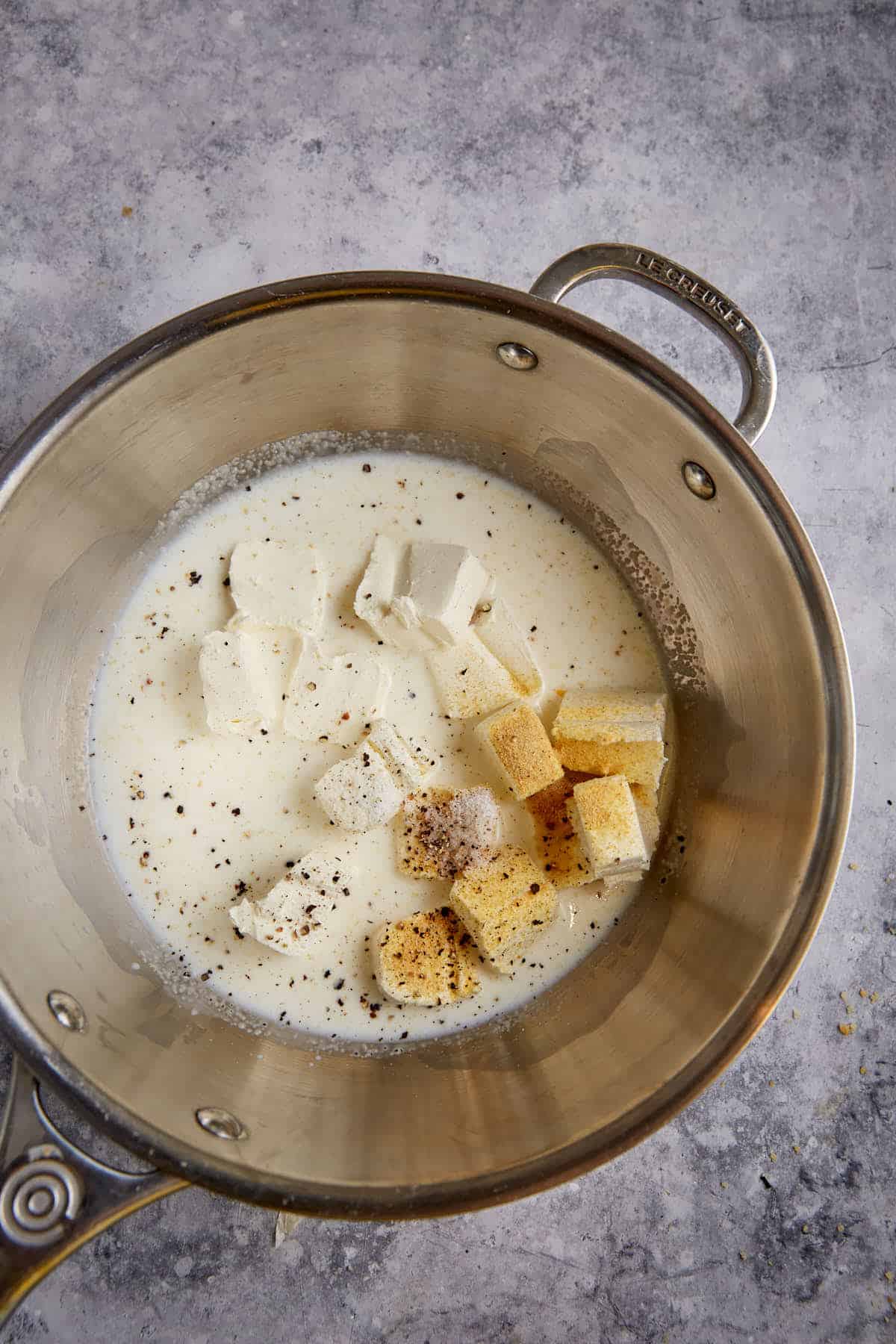 Cream cheese and seasonings in a saucepan.