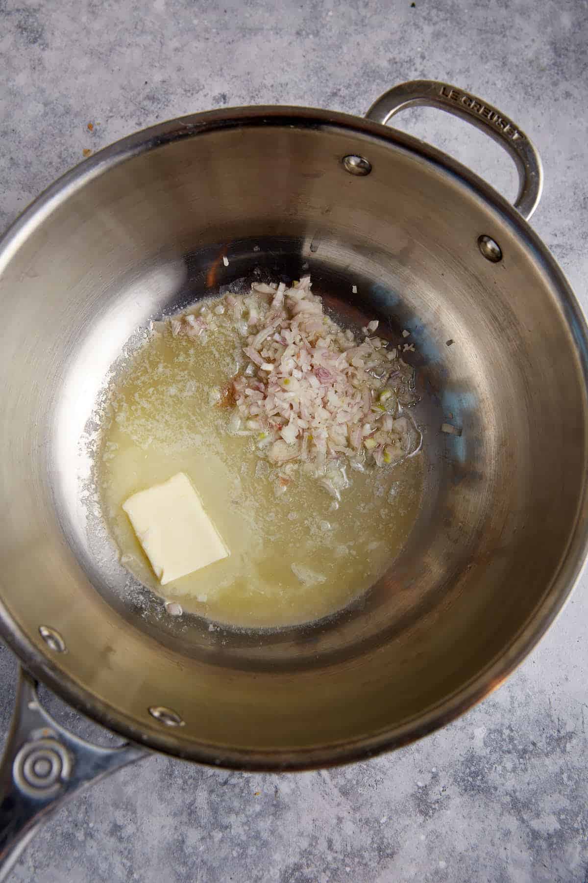 Butter and shallots in a saucepan.